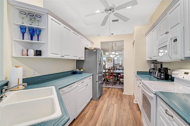 kitchen with sink, light hardwood / wood-style floors, white appliances, ceiling fan with notable chandelier, and white cabinets