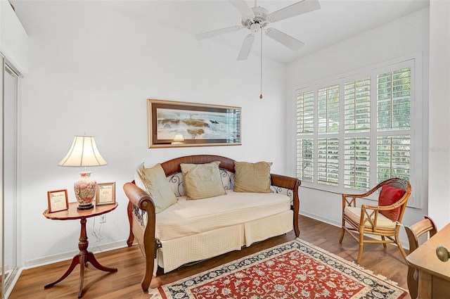 sitting room featuring wood-type flooring and ceiling fan