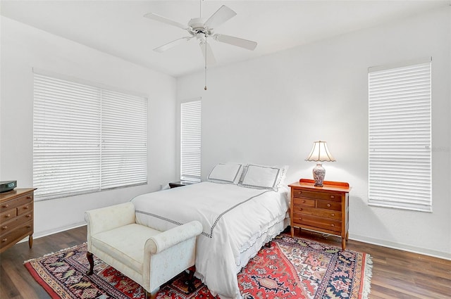 bedroom with ceiling fan and dark hardwood / wood-style flooring