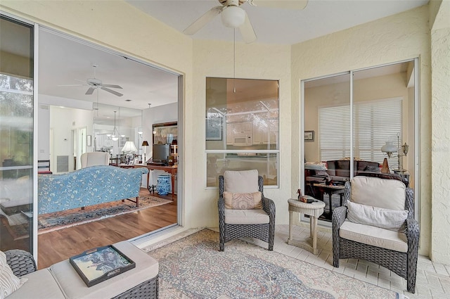 sunroom / solarium with ceiling fan