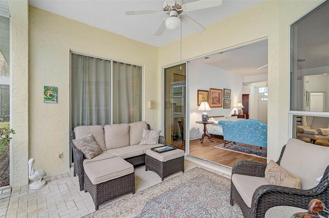 living room with ceiling fan and light hardwood / wood-style floors