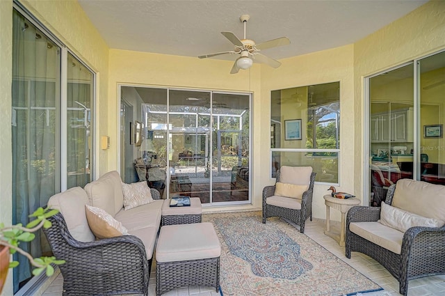 sunroom / solarium featuring ceiling fan