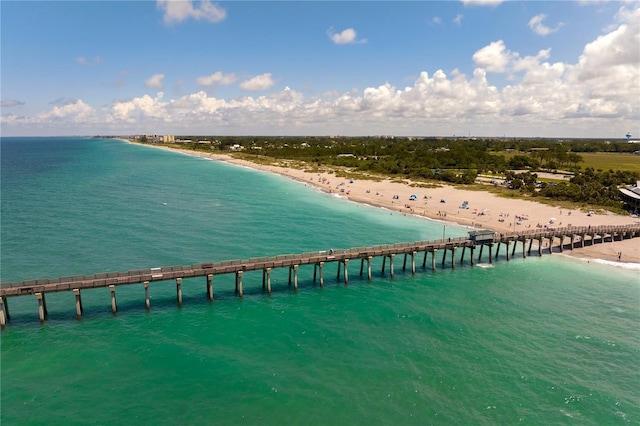 bird's eye view with a water view and a beach view