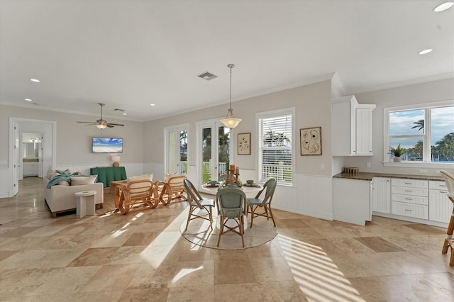 dining area featuring ceiling fan and ornamental molding