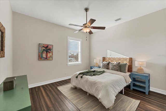 bedroom with dark hardwood / wood-style flooring and ceiling fan