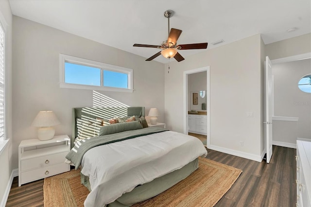 bedroom featuring ensuite bath, dark hardwood / wood-style floors, and ceiling fan