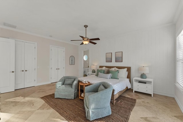 bedroom featuring multiple closets, ornamental molding, and ceiling fan