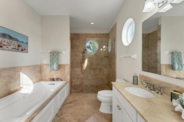 full bathroom featuring vanity, separate shower and tub, tile walls, and toilet