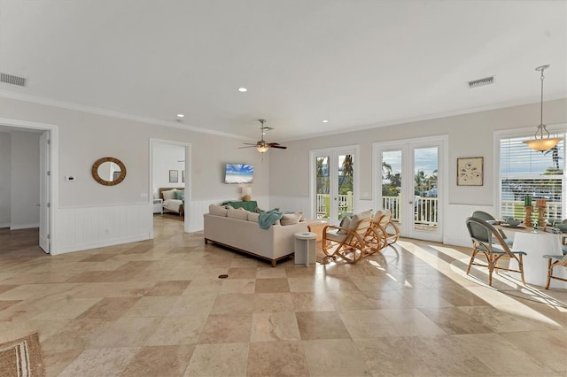 living room featuring crown molding, french doors, and ceiling fan