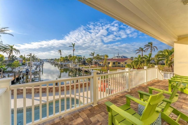 view of patio featuring a water view and a boat dock