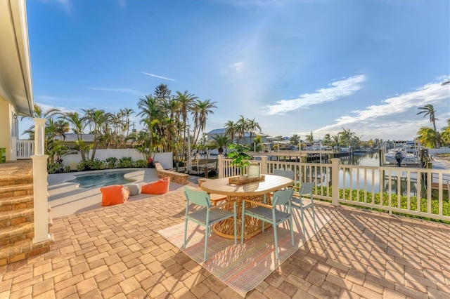 view of patio featuring a fenced in pool and a water view