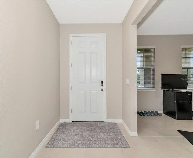 entryway featuring light tile patterned flooring and plenty of natural light