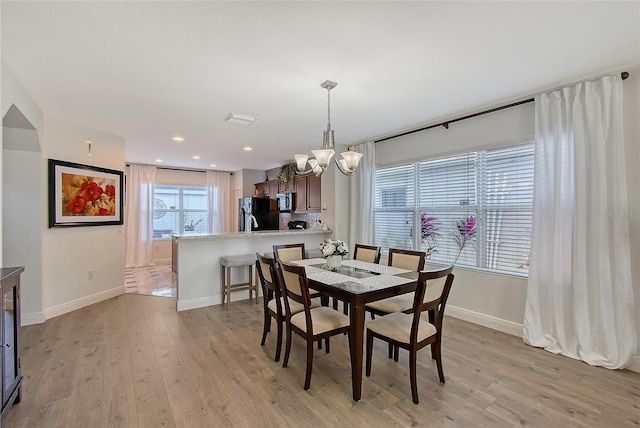 dining room featuring an inviting chandelier and light hardwood / wood-style floors