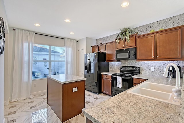 kitchen with sink, backsplash, black appliances, and a kitchen island