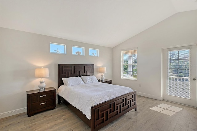 bedroom featuring lofted ceiling and light hardwood / wood-style flooring