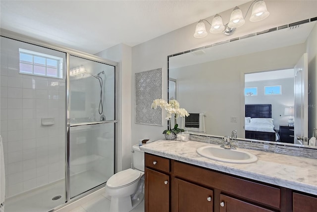 bathroom featuring tile patterned floors, toilet, a shower with shower door, and vanity