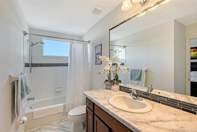 full bathroom featuring vanity, shower / tub combo, and toilet