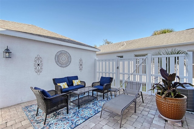 view of patio with outdoor lounge area and central air condition unit