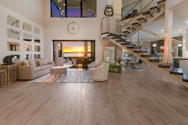 interior space with a high ceiling and hardwood / wood-style flooring