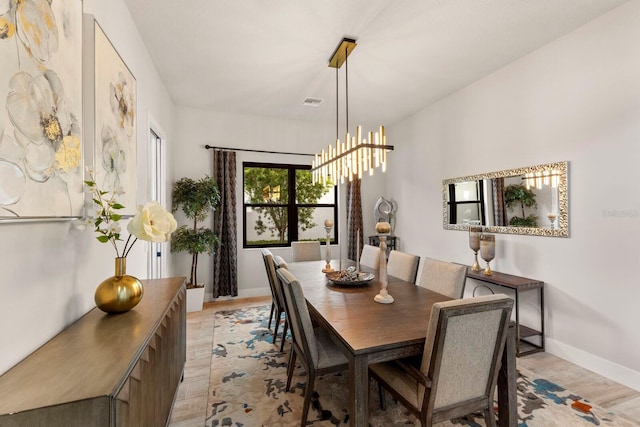 dining room featuring a chandelier and light wood-type flooring