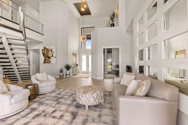 living room featuring hardwood / wood-style flooring and a towering ceiling