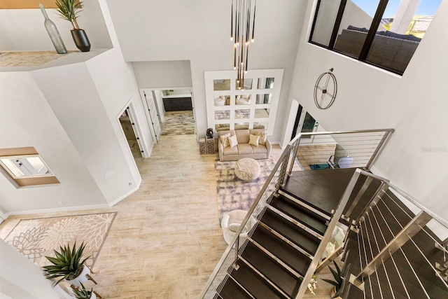 stairway featuring hardwood / wood-style floors and a high ceiling