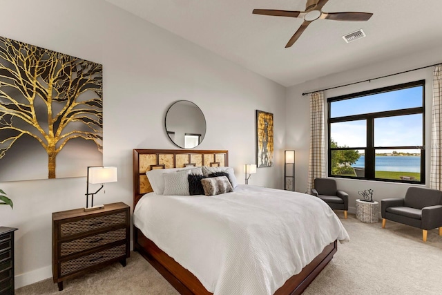 carpeted bedroom with vaulted ceiling, a water view, and ceiling fan