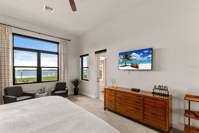 bedroom featuring a water view, ceiling fan, and light colored carpet