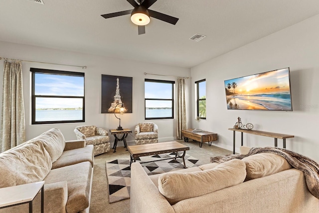 carpeted living room featuring ceiling fan