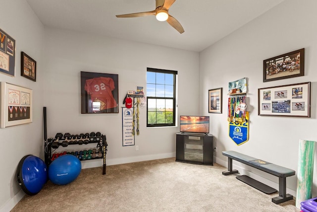 exercise area featuring light carpet and ceiling fan