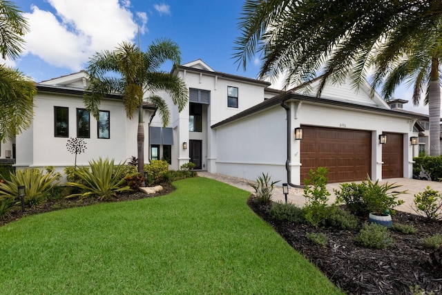 view of front facade with a garage and a front lawn