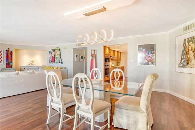 dining room with wood-type flooring and ornamental molding