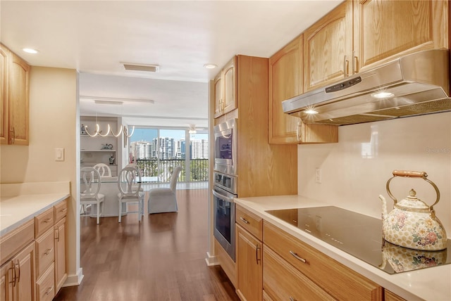 kitchen with dark wood-type flooring, light brown cabinetry, oven, and black electric cooktop