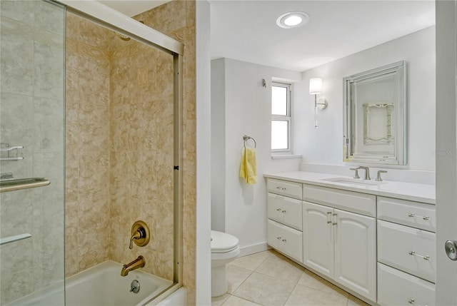 full bathroom with toilet, vanity, bath / shower combo with glass door, and tile patterned flooring