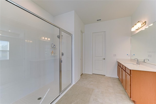 bathroom featuring tile patterned floors, vanity, and an enclosed shower