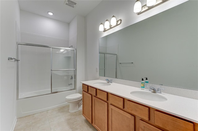 full bathroom with vanity, toilet, tile patterned flooring, and combined bath / shower with glass door