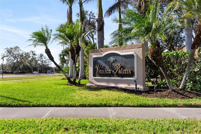 community / neighborhood sign with a lawn