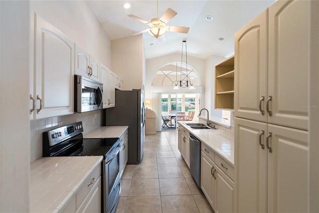 kitchen featuring sink, hanging light fixtures, tile counters, stainless steel appliances, and backsplash