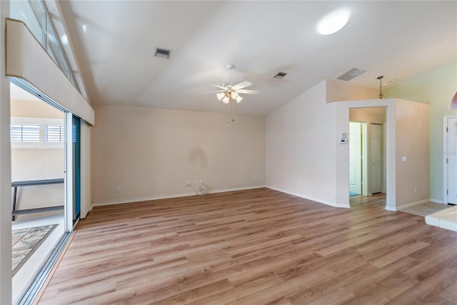 empty room with ceiling fan, lofted ceiling, and light hardwood / wood-style floors