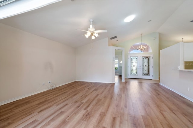 interior space featuring french doors, lofted ceiling, ceiling fan with notable chandelier, and light hardwood / wood-style floors