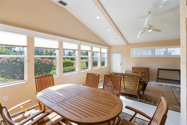 sunroom / solarium with ceiling fan and vaulted ceiling with beams