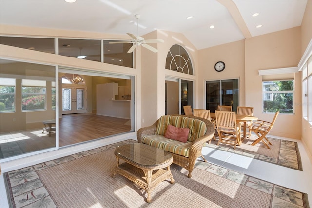 sunroom / solarium featuring vaulted ceiling, ceiling fan, and french doors