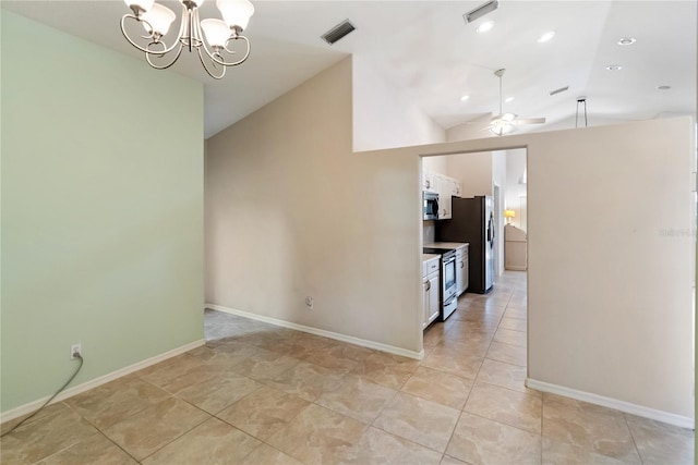 interior space with vaulted ceiling, ceiling fan with notable chandelier, and light tile patterned floors