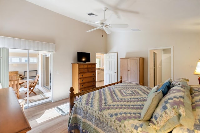 bedroom with high vaulted ceiling and light hardwood / wood-style flooring