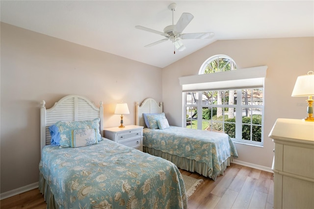 bedroom featuring ceiling fan, lofted ceiling, and light hardwood / wood-style floors