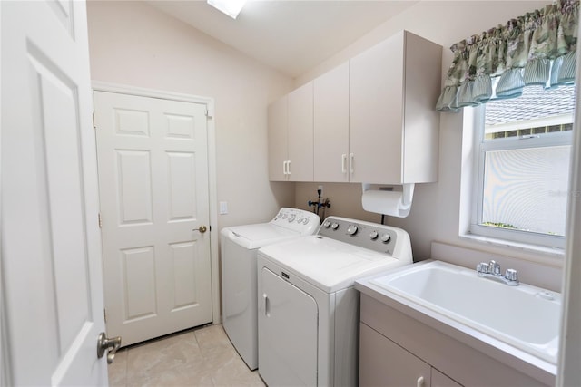 laundry area featuring cabinets, independent washer and dryer, light tile patterned flooring, and sink