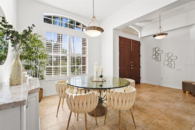 dining area with light tile patterned floors and baseboards