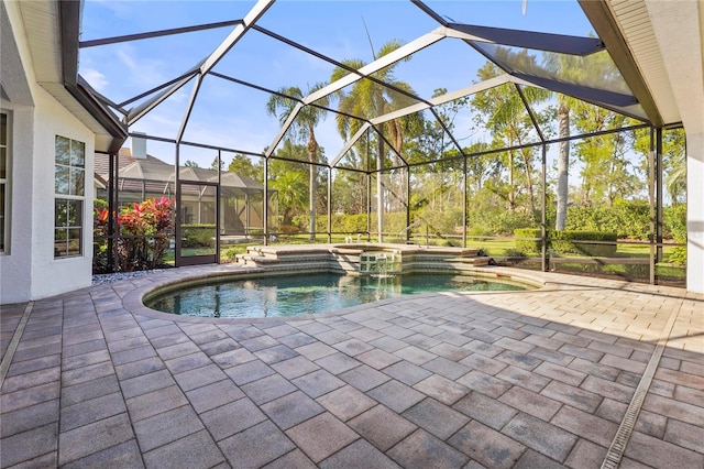 view of pool featuring a pool with connected hot tub, a lanai, and a patio