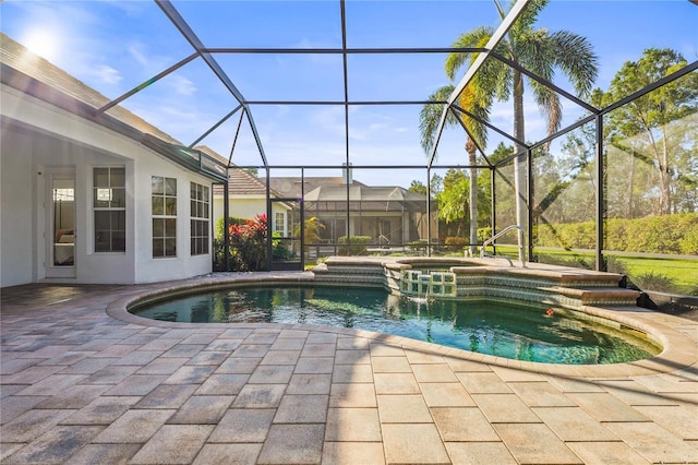 view of swimming pool featuring a lanai, a patio area, and a pool with connected hot tub