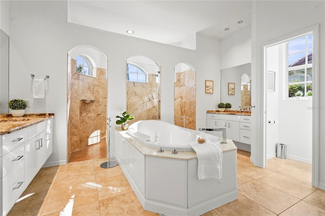 full bath featuring recessed lighting, vanity, a bath, baseboards, and tile patterned floors